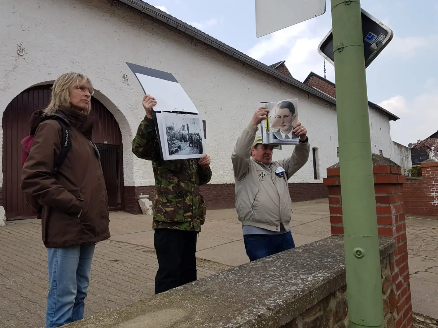 Zwei Männer zeigen Gemälde von Trostorf